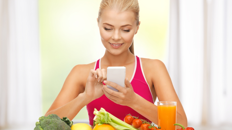 woman with fruits, vegetables and smartphone